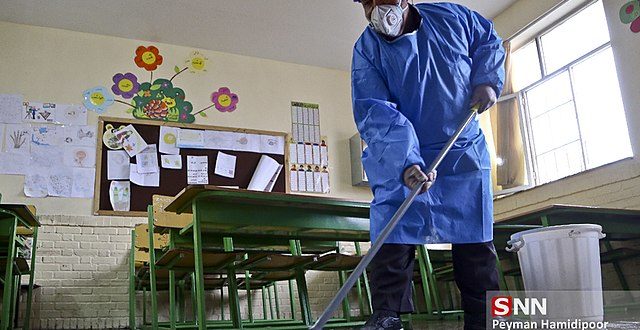 A worker disinfects a school in Bojnord, Iran