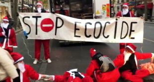 Protesters Dressed as Santa Block Street to Protest Climate Change